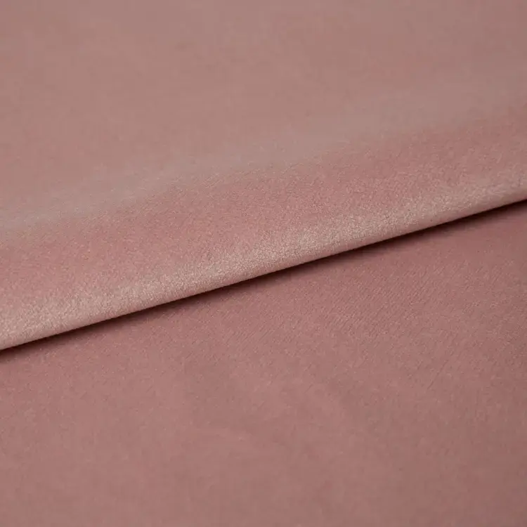 Close-up of dusty rose pink velvet fabric.