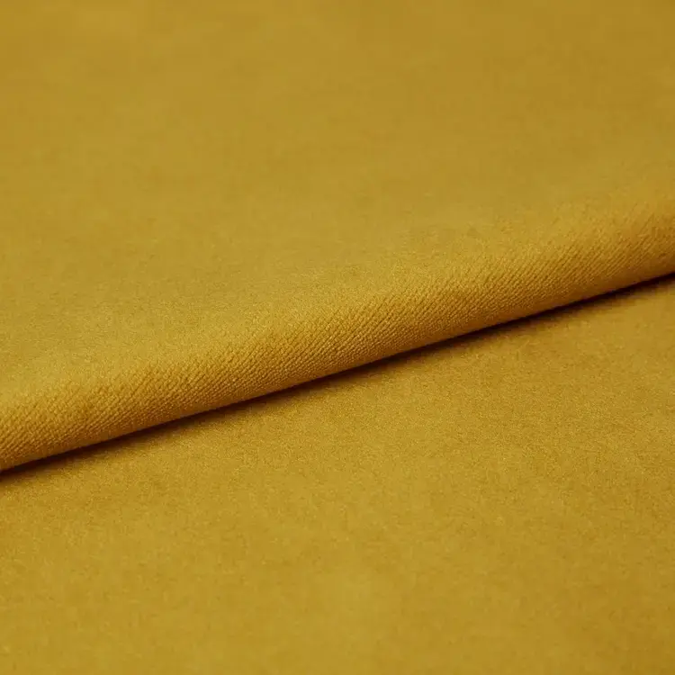Close-up of mustard yellow or gold velvet fabric.