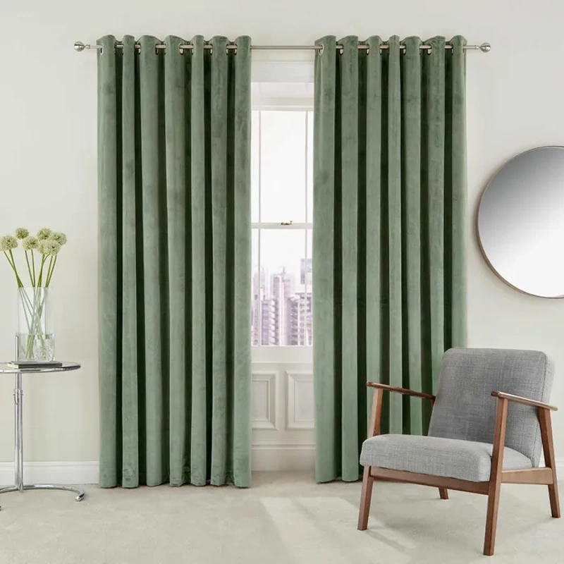 Green velvet curtain with grommets and city view
