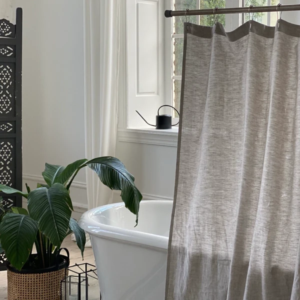 Light gray shower curtain in serene bathroom setting