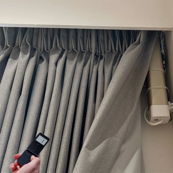 Motorized gray pinch pleat curtain with remote