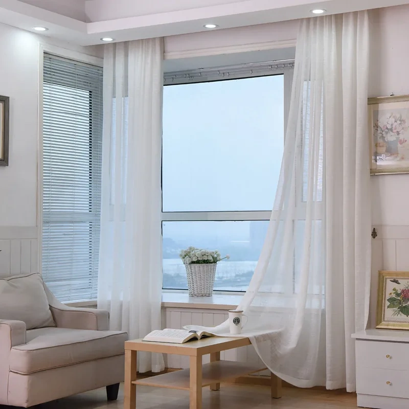 Sheer white curtain with soft daylight and floral decor